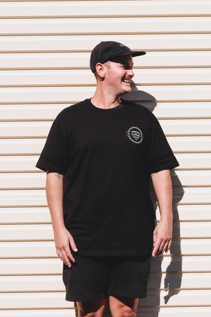 Coffee roaster wearing branded t-shirt