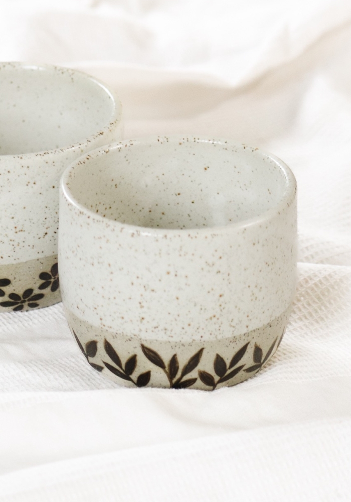 Handcrafted coffee cup with leaf motifs