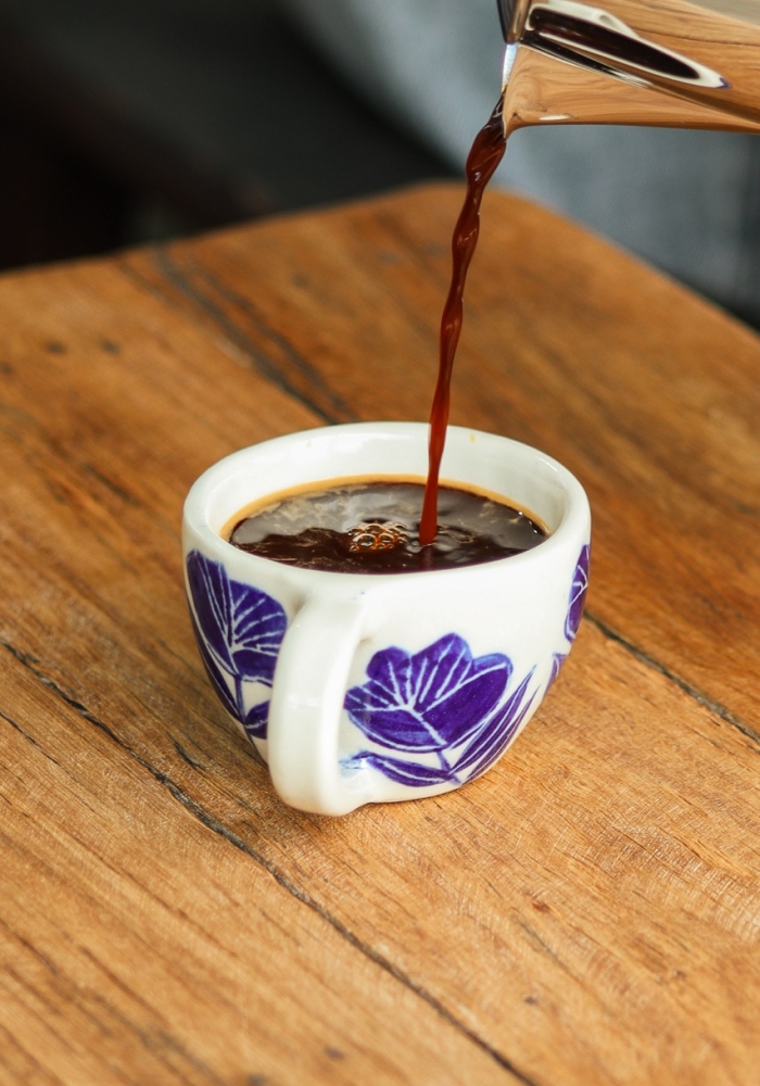 Handcrafted espresso cup with floral motifs