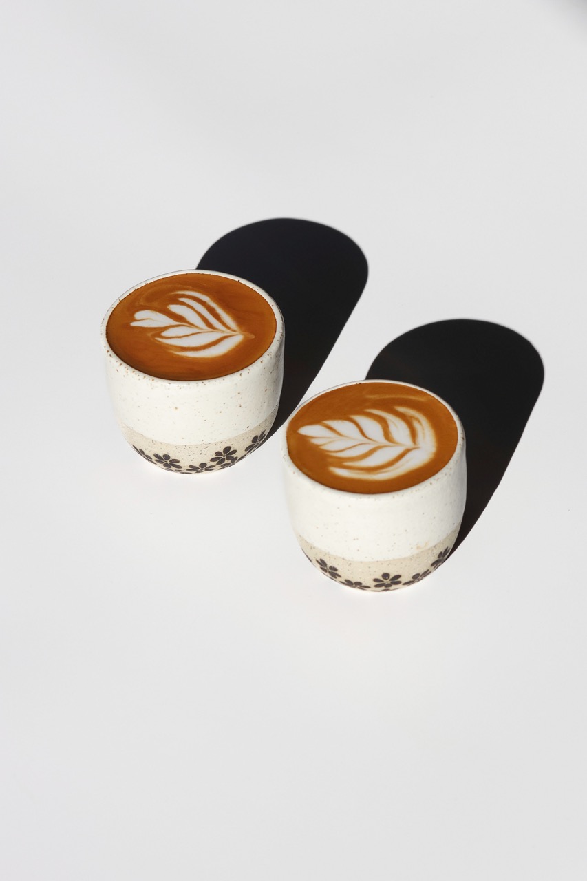 Piccolos served in handmade keep cups with flower motifs